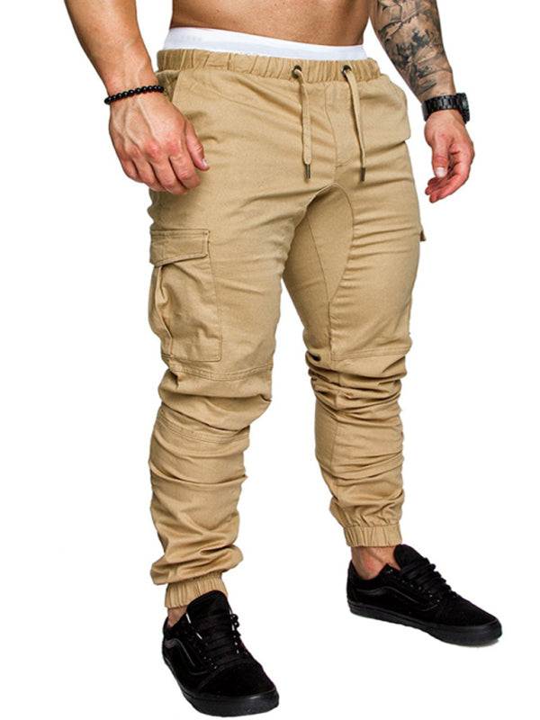 Men's elastic waist baggy trousers in solid color with flap pockets.