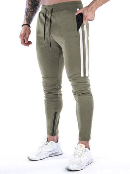 Men's training joggers with contrasting stripe and zipper detail.