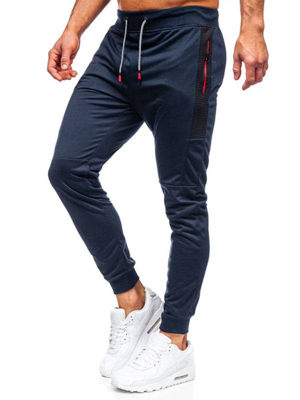 Men's casual sweatpants with contrasting color pocket design and elastic fit.