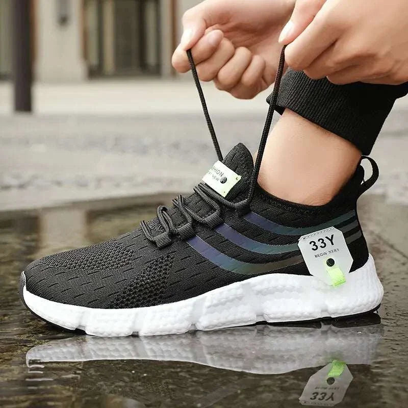 Men’s breathable lightweight black sport shoes with mesh upper and lace-up design for outdoor activities.