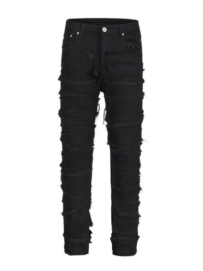 Men's washed distressed panelled jeans with raw hem and trendy design.