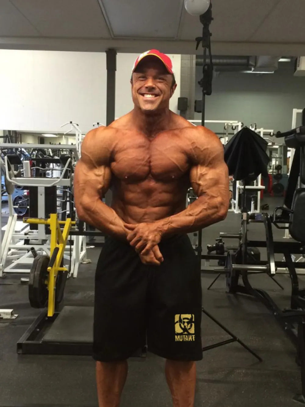 Men's drawstring shorts in a gym setting.