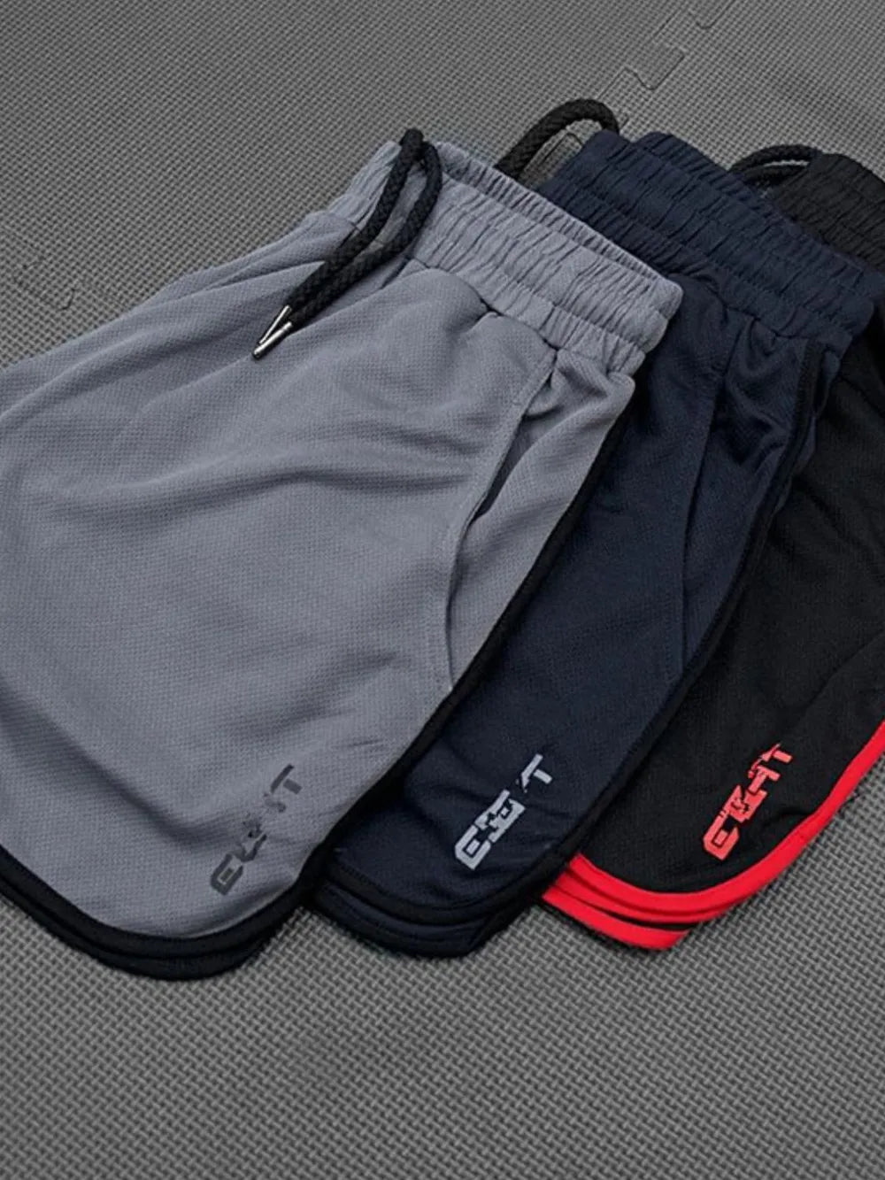 Men's drawstring shorts with pockets in multiple colors, 100% polyester.