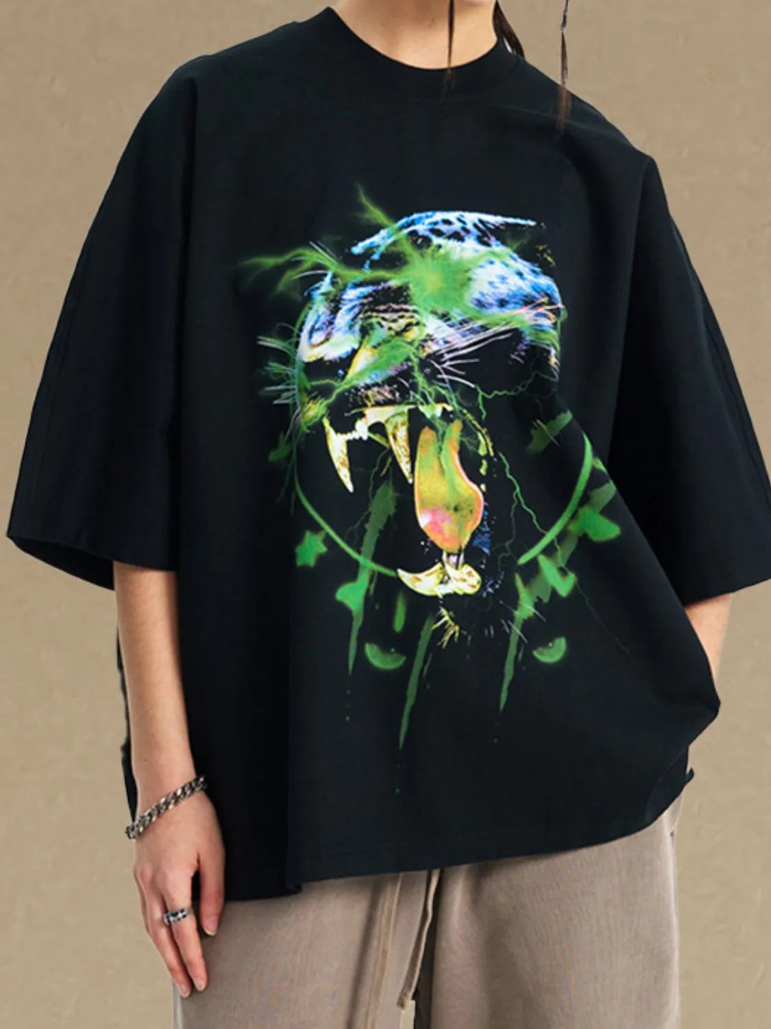 Men's graphic round neck half sleeve t-shirt in black with colorful animal design.