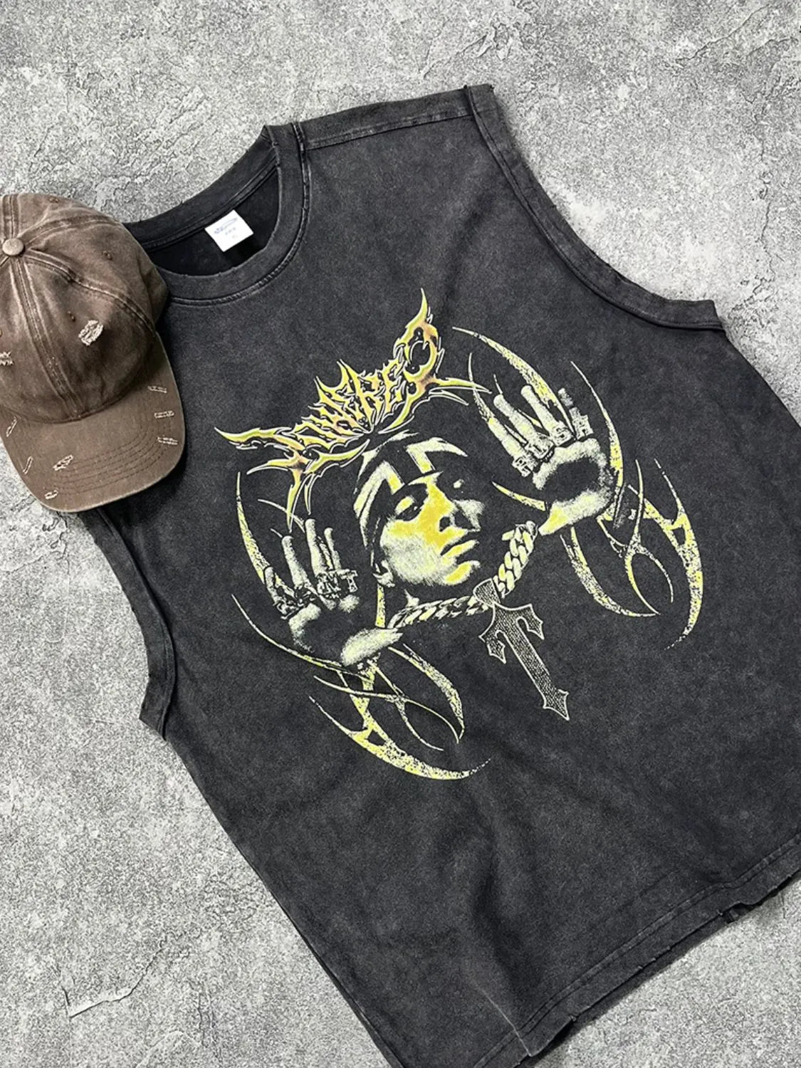 Men's graphic round neck tank with artistic design on dark fabric.
