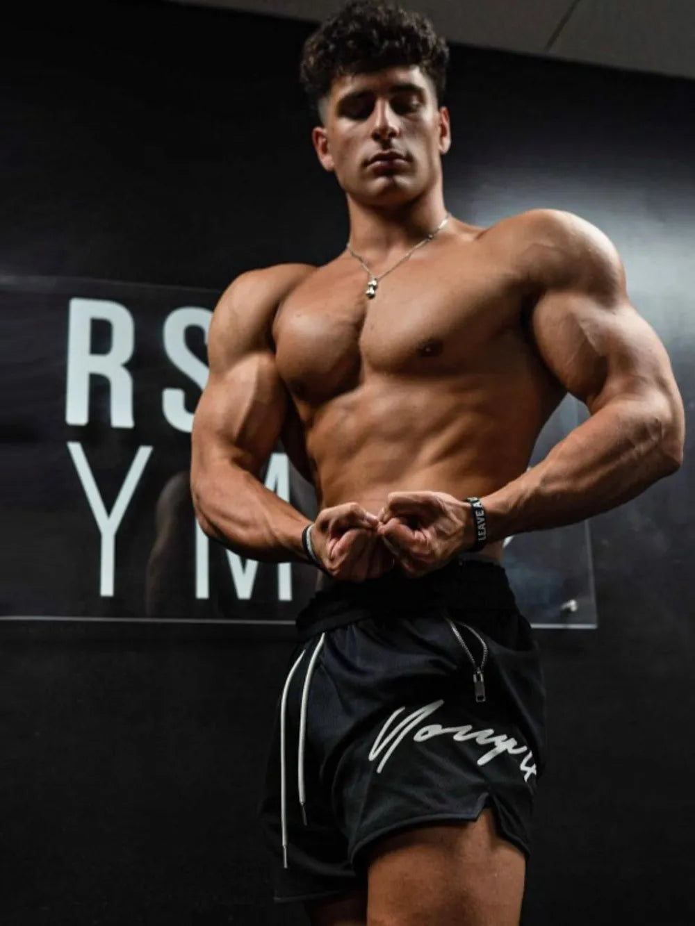Men's plus size drawstring shorts in a gym setting.