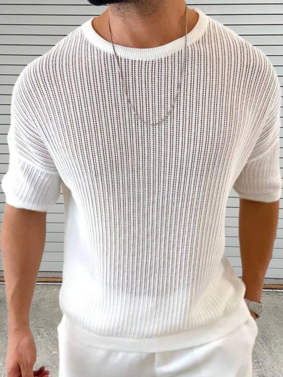 Men's round neck knit top in white, drop shoulder style.