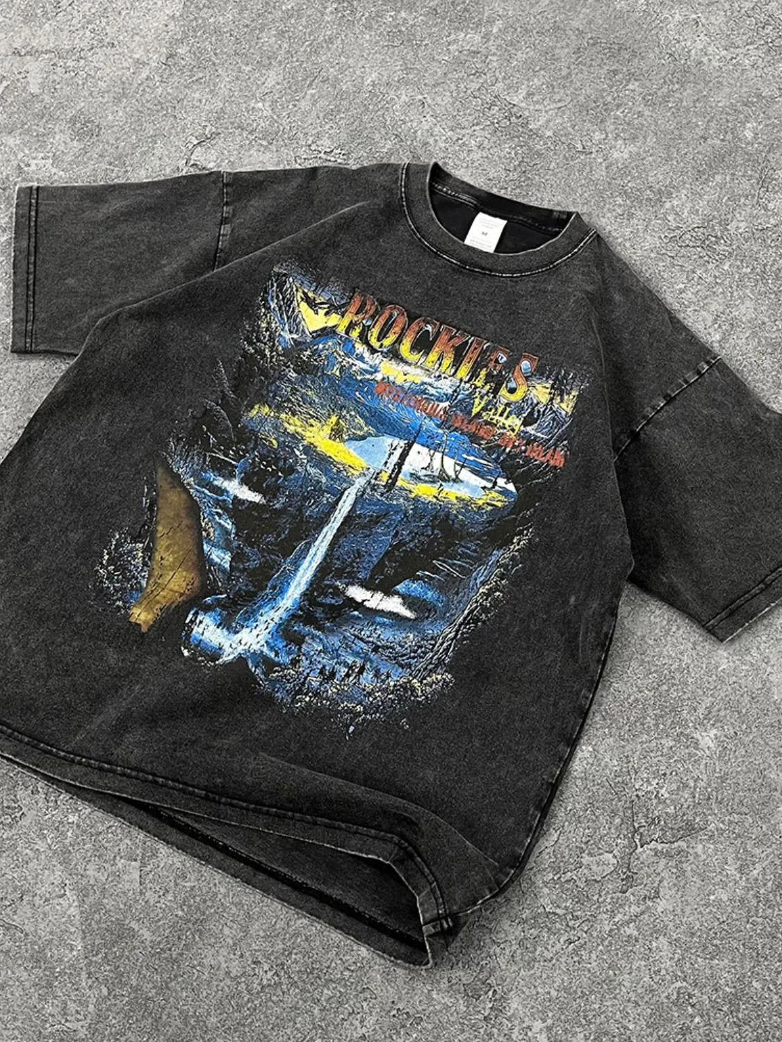 Men's graphic round neck half sleeve T-shirt with bold print on dark fabric.