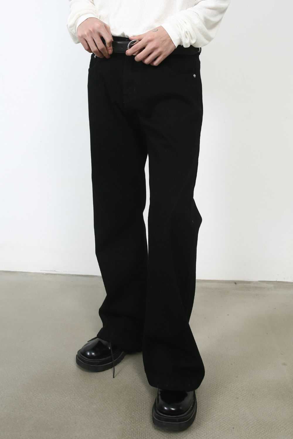Men's mid rise bootcut jeans in black, no stretch, paired with a white shirt.