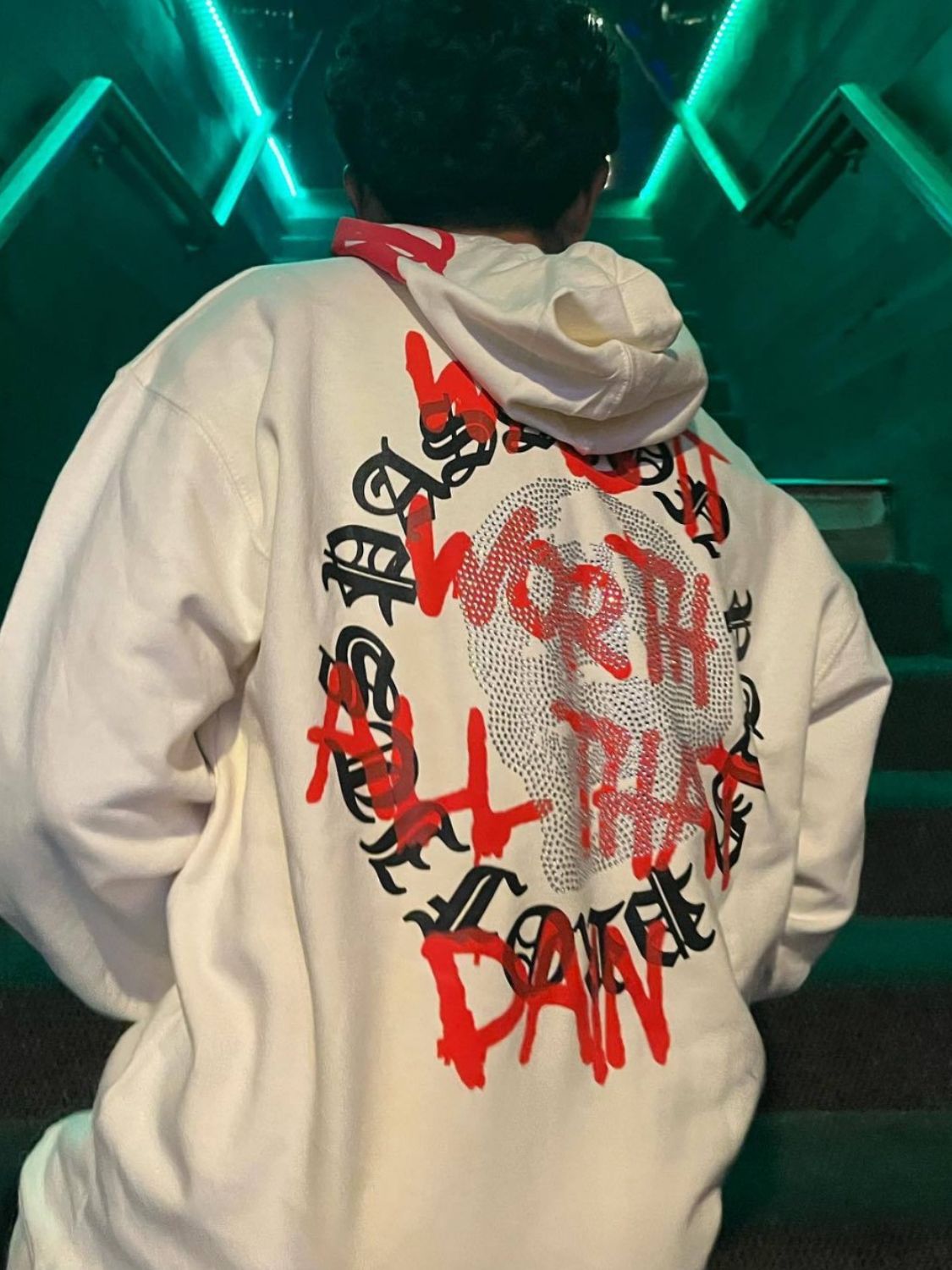 Men's rhinestone hoodie with red and black lettering design on back, slightly stretchy material.