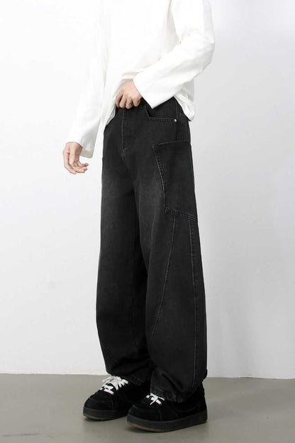 Men's wide leg jeans with pockets, black, styled with black shoes and white shirt.