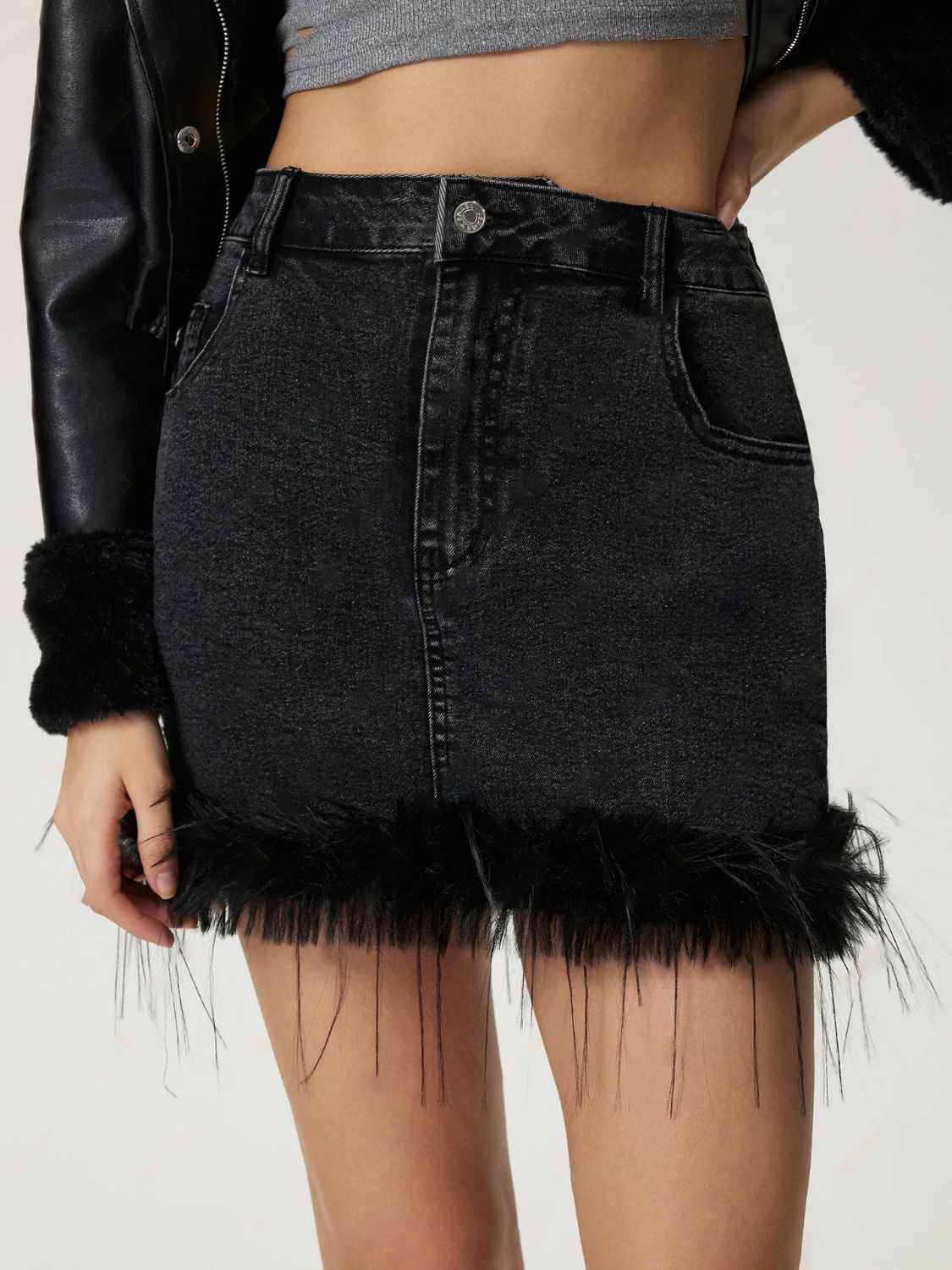 Mini denim skirt with plush hem, buttoned front, and pockets.