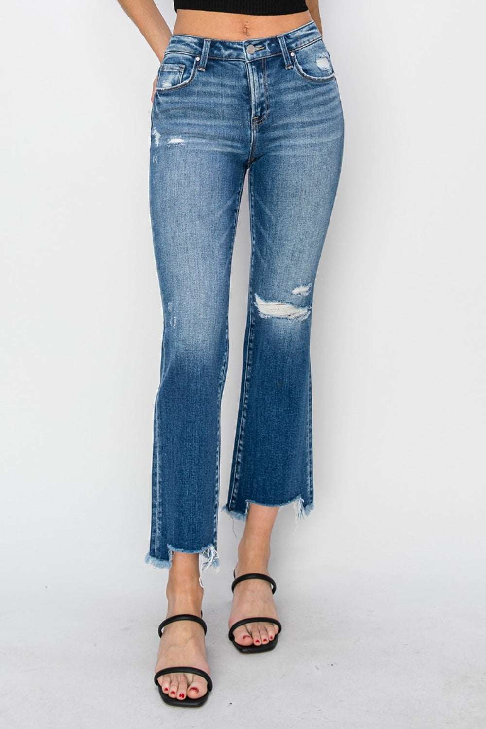 Frayed step hem ankle straight jeans with distressed details, front view.