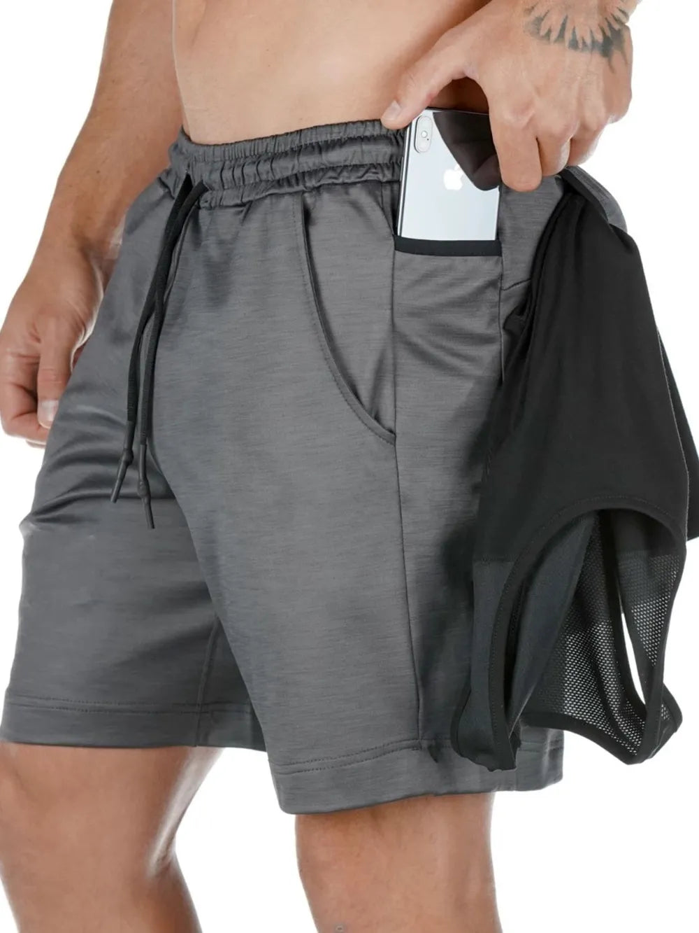 Men's drawstring active shorts with pockets in gray, slightly stretchy polyester blend, demonstrating easy pocket storage.