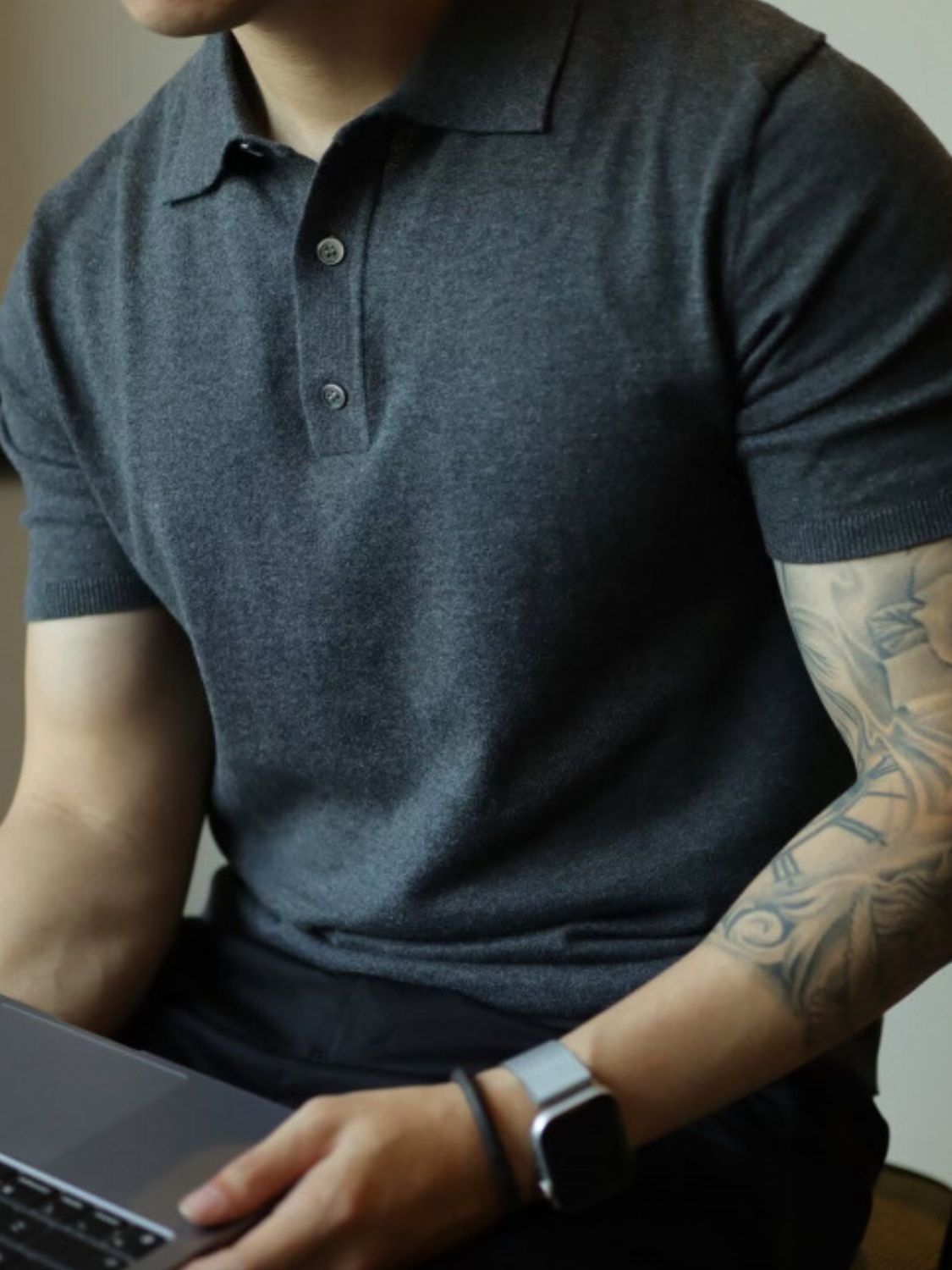 Men's plus size short sleeve polo with button detail in dark color, slightly stretchy material.