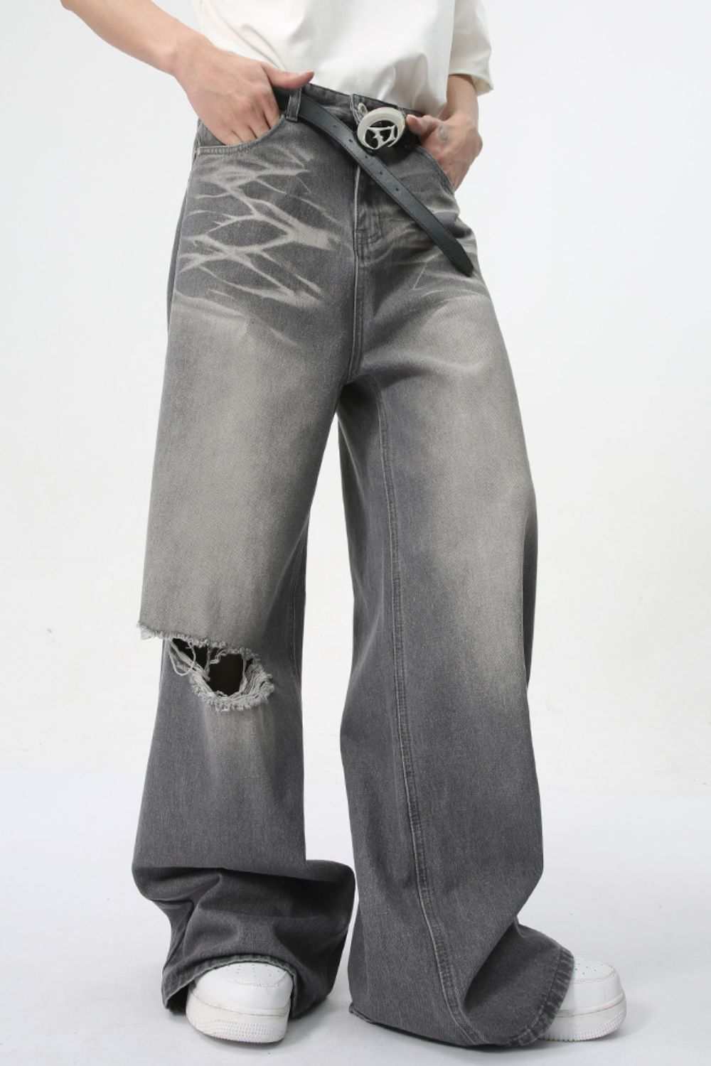 Distressed wide leg jeans with pockets featuring no stretch material.