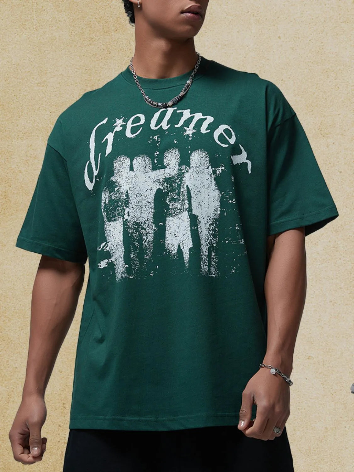 Men's graphic round neck half sleeve t-shirt in green with "Dreamer" print.