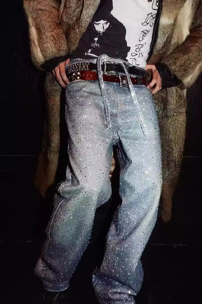 Men's washed rhinestone jeans with rhinestone belt, worn with a fashionable coat, highlighting the sparkling details.
