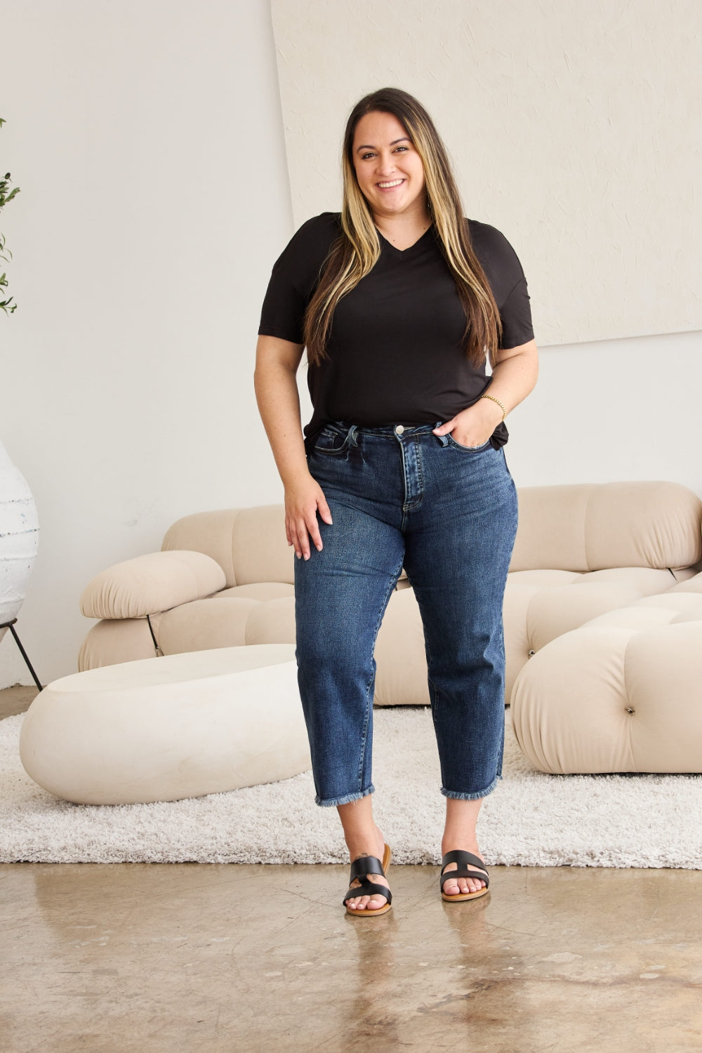 Tummy Control High Waist Raw Hem Distressed Jeans with black tee, worn by a model indoors.