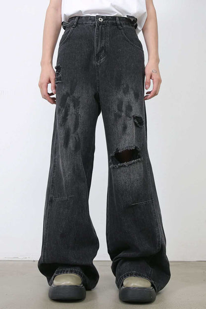 Men's distressed baggy jeans with raw hem and black wash.