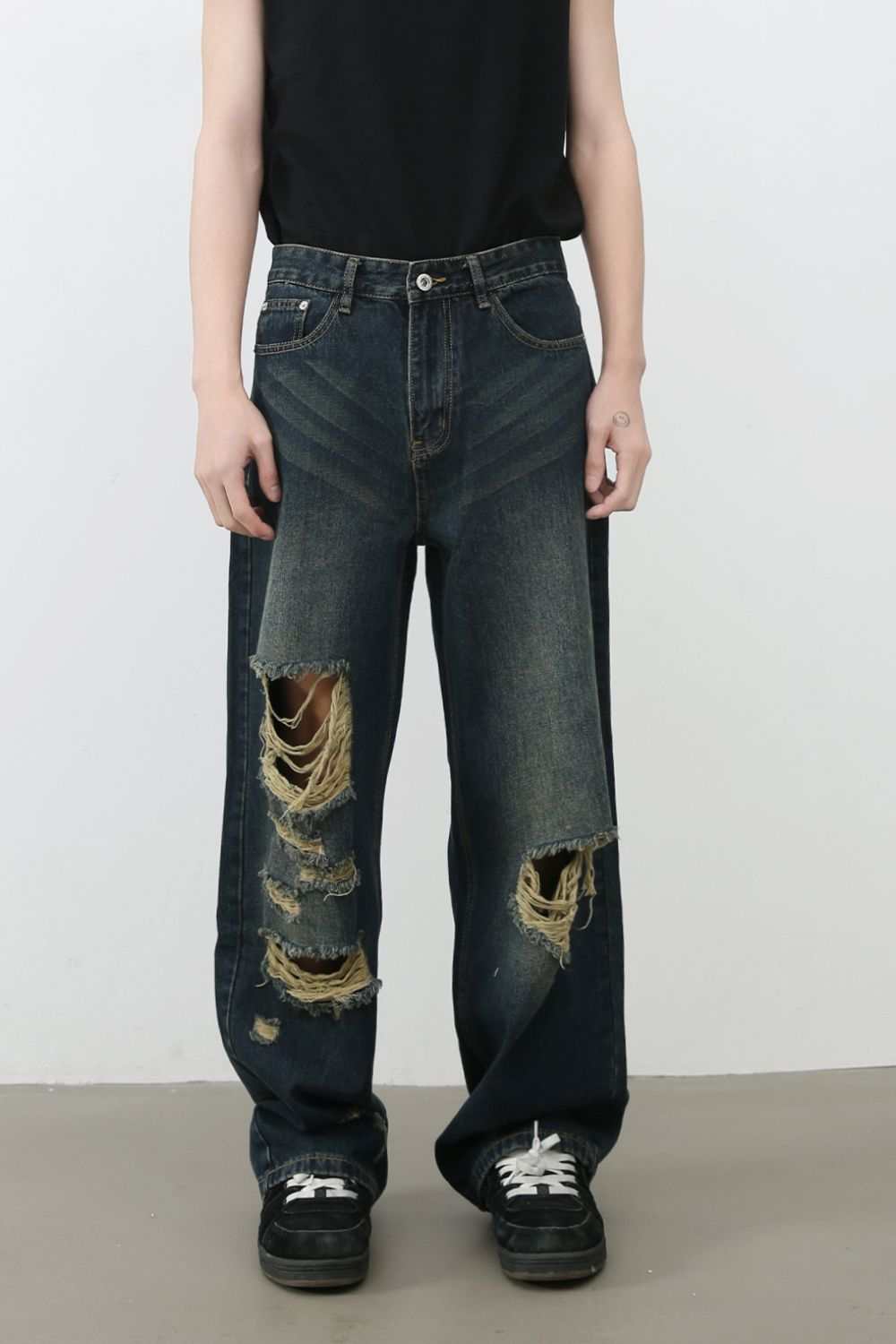 Men's distressed wide leg jeans in dark denim with large rips, featuring no stretch and machine washable material.