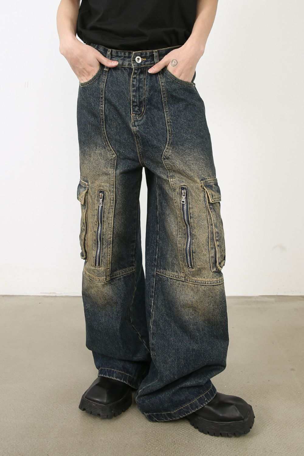Men's wide leg cargo jeans with pocket details and zipper accents.