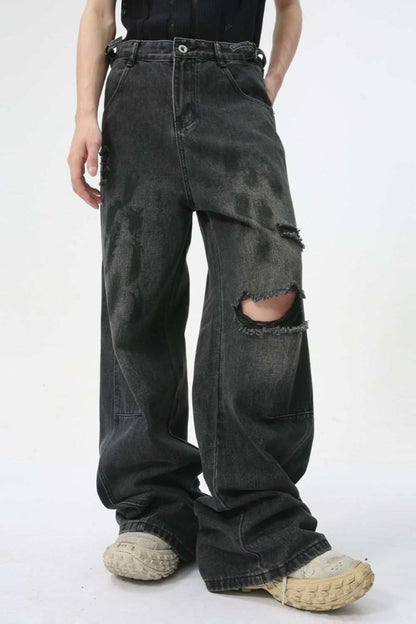 Distressed jeans with pockets, slightly stretchy fabric, black color, ripped knee design.
