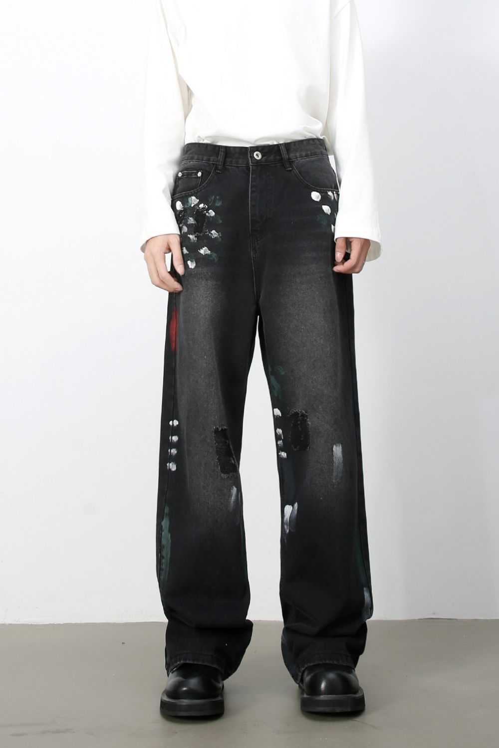 Men's paint loose jeans with a basic style in black, featuring minimalistic paint splatter design.