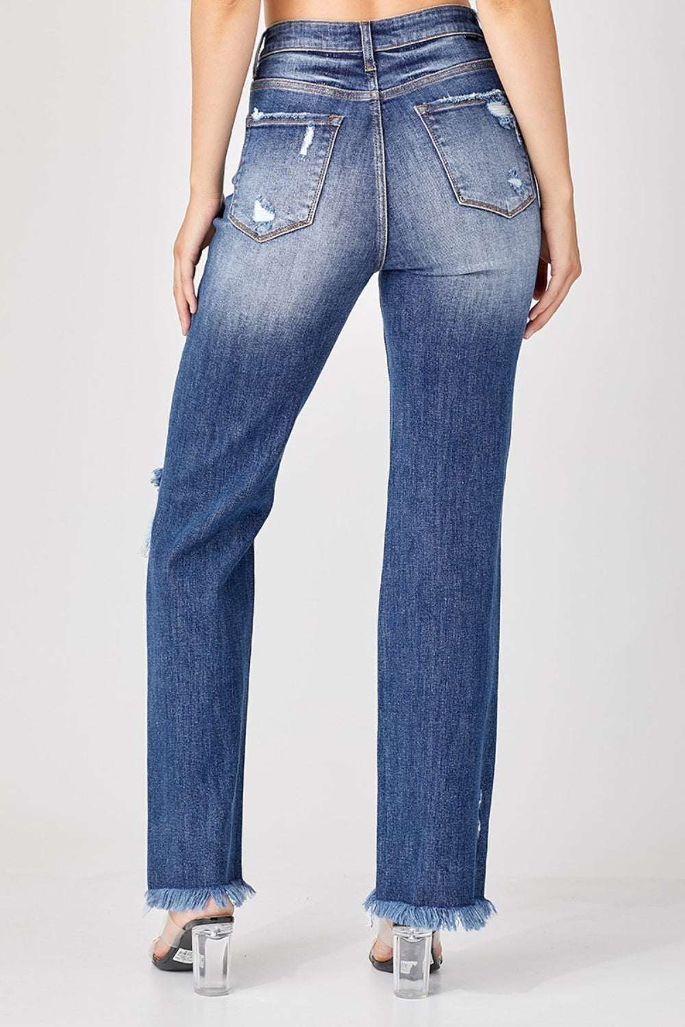 Risen full size raw hem distressed straight jeans from the back, showing distressed details and raw hem.