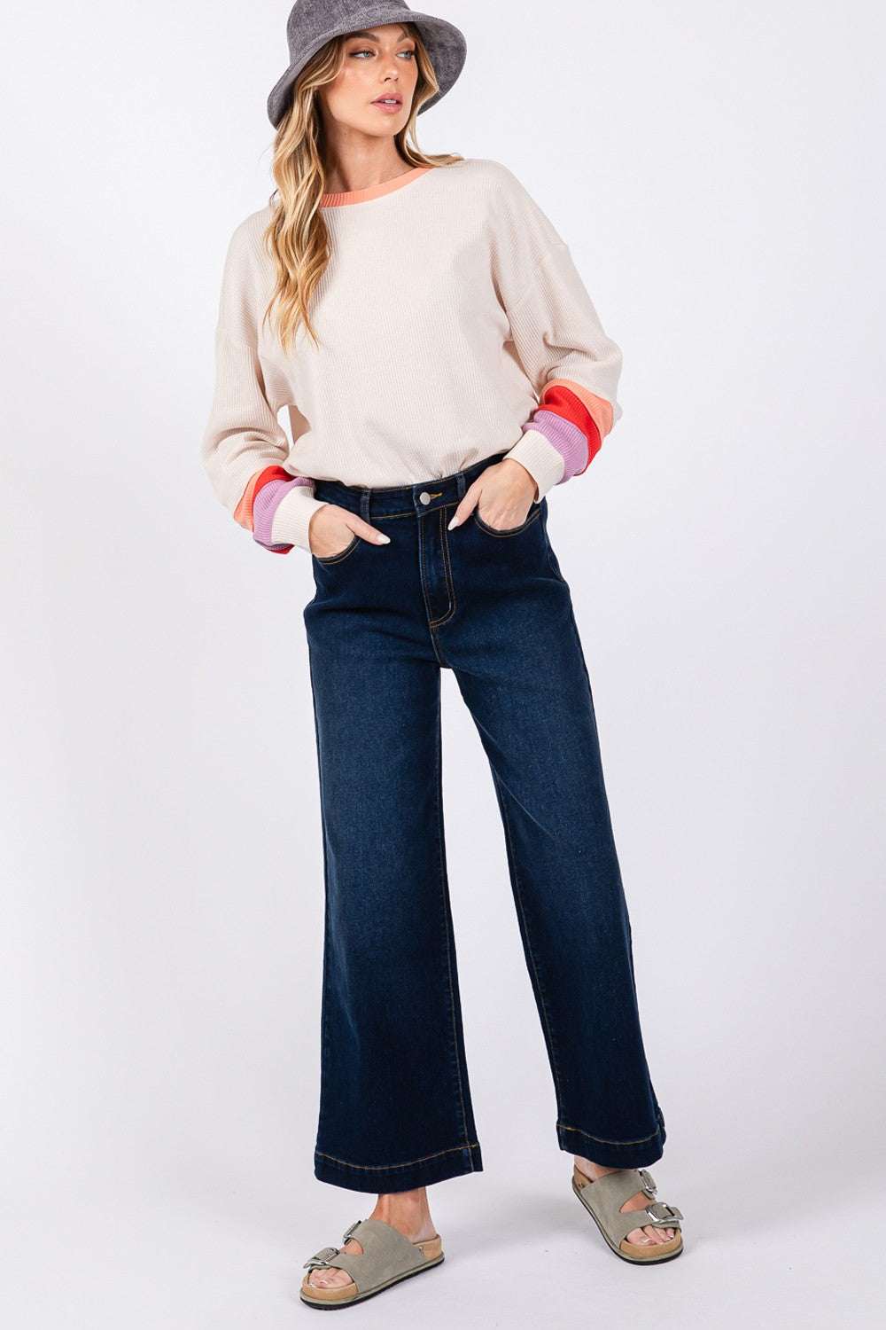High Waist Wide Leg Jeans with pockets, paired with a casual top and sandals.