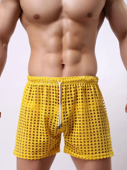 Men's yellow openwork drawstring shorts, sheer nylon fabric.