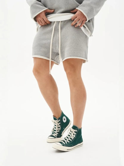 Men's plus size drawstring shorts in gray, shown worn with green high-top sneakers.
