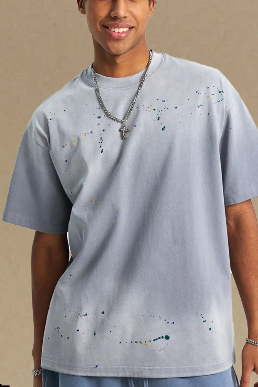 Men's round neck half sleeve t-shirt in light gray with subtle paint splatter design.