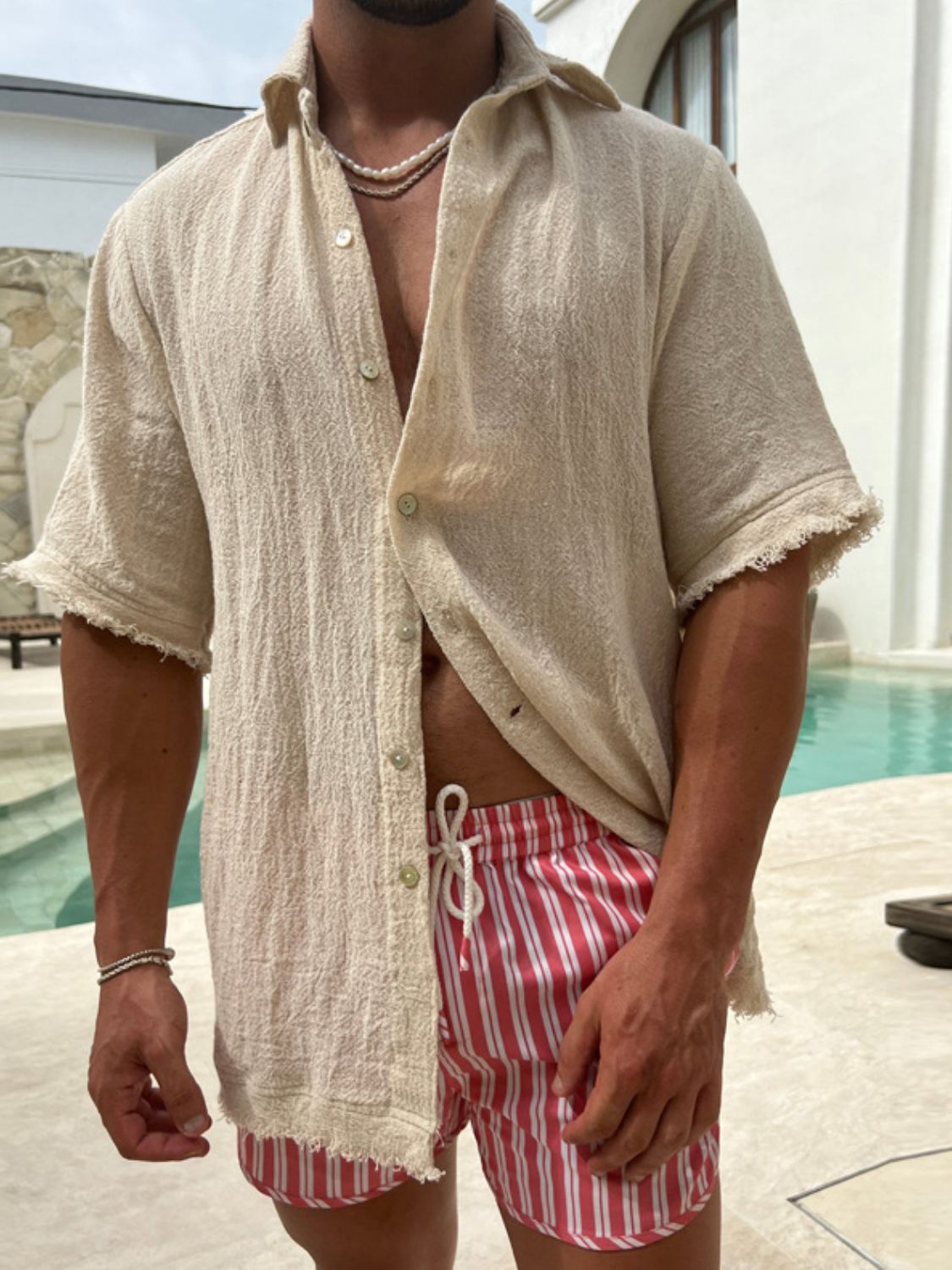 Men's plus size raw hem button down collared neck shirt with fringe detail, slightly stretchy fabric, beige color.