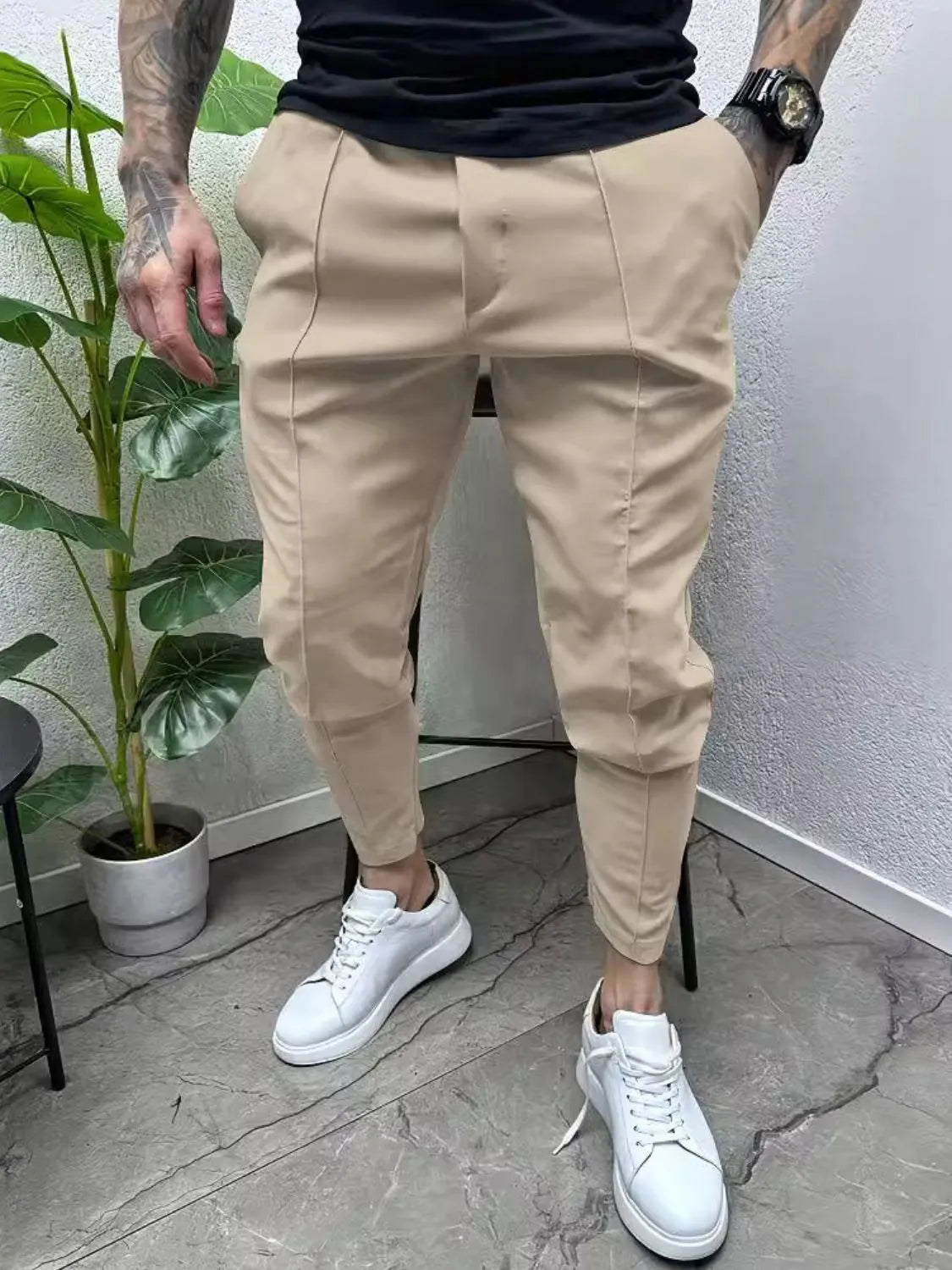 Men's full size pockets joggers plus size in beige, featuring a basic style, cotton-spandex blend, worn with white sneakers.