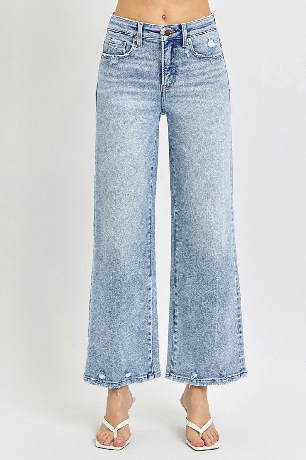 Full size tummy control high rise crop wide leg jeans with washed finish and pockets.