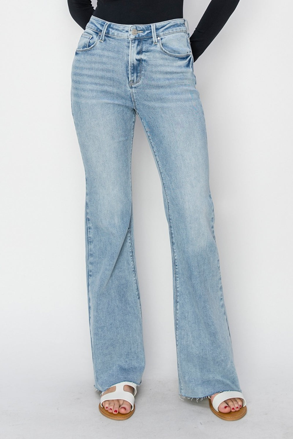 Full size high rise raw cut hem bootcut jeans with no stretch and pocket detailing.