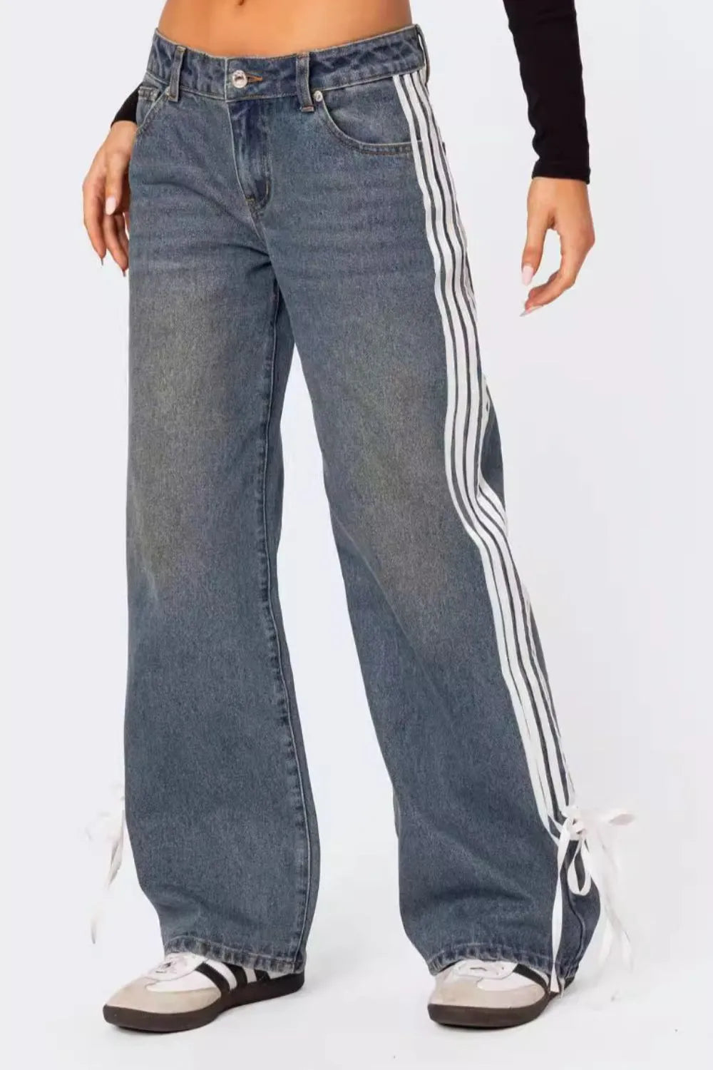 Side striped loose fit jeans with tied hem and button closure.