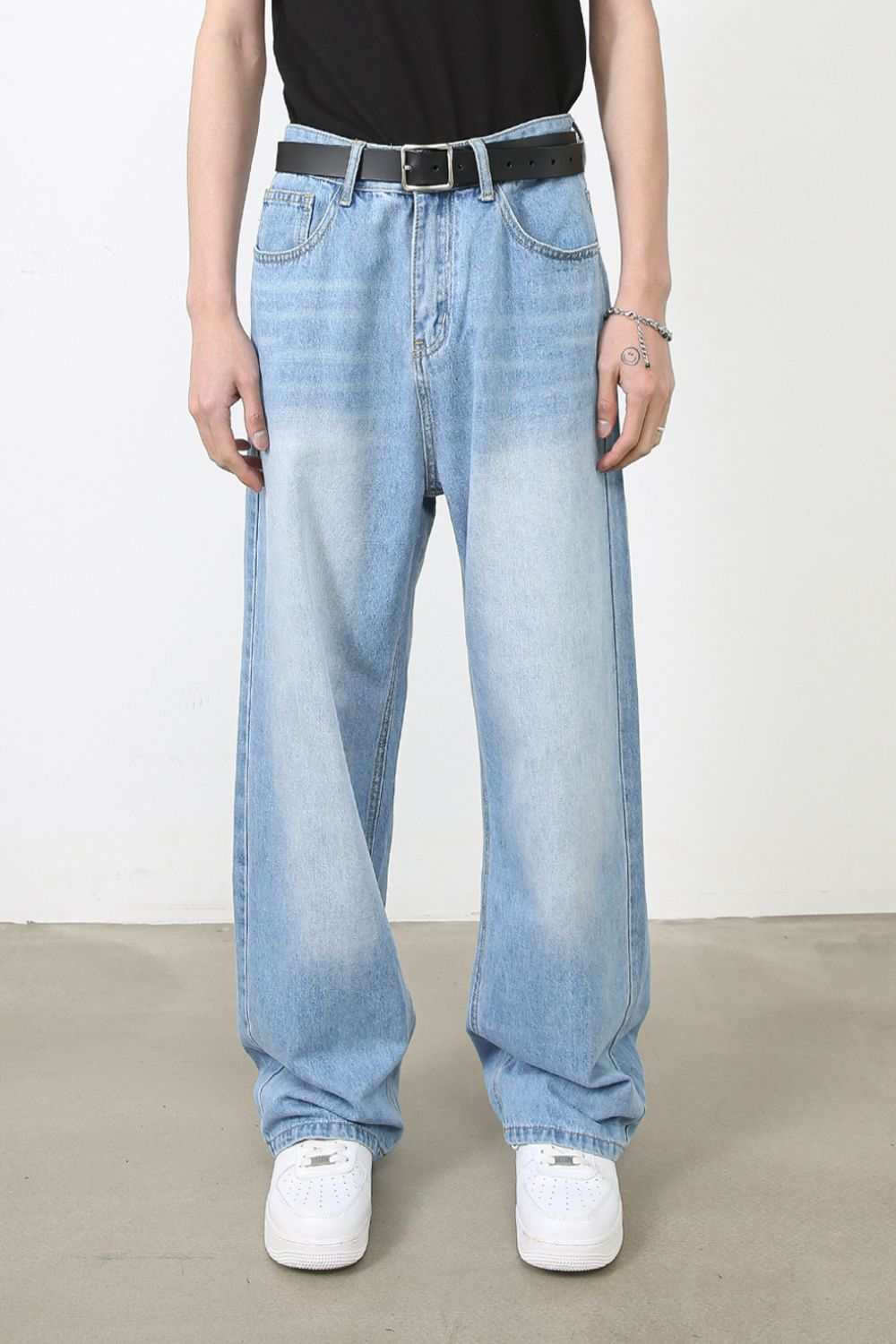 Men's wide straight jeans with pockets and no stretch in light blue.