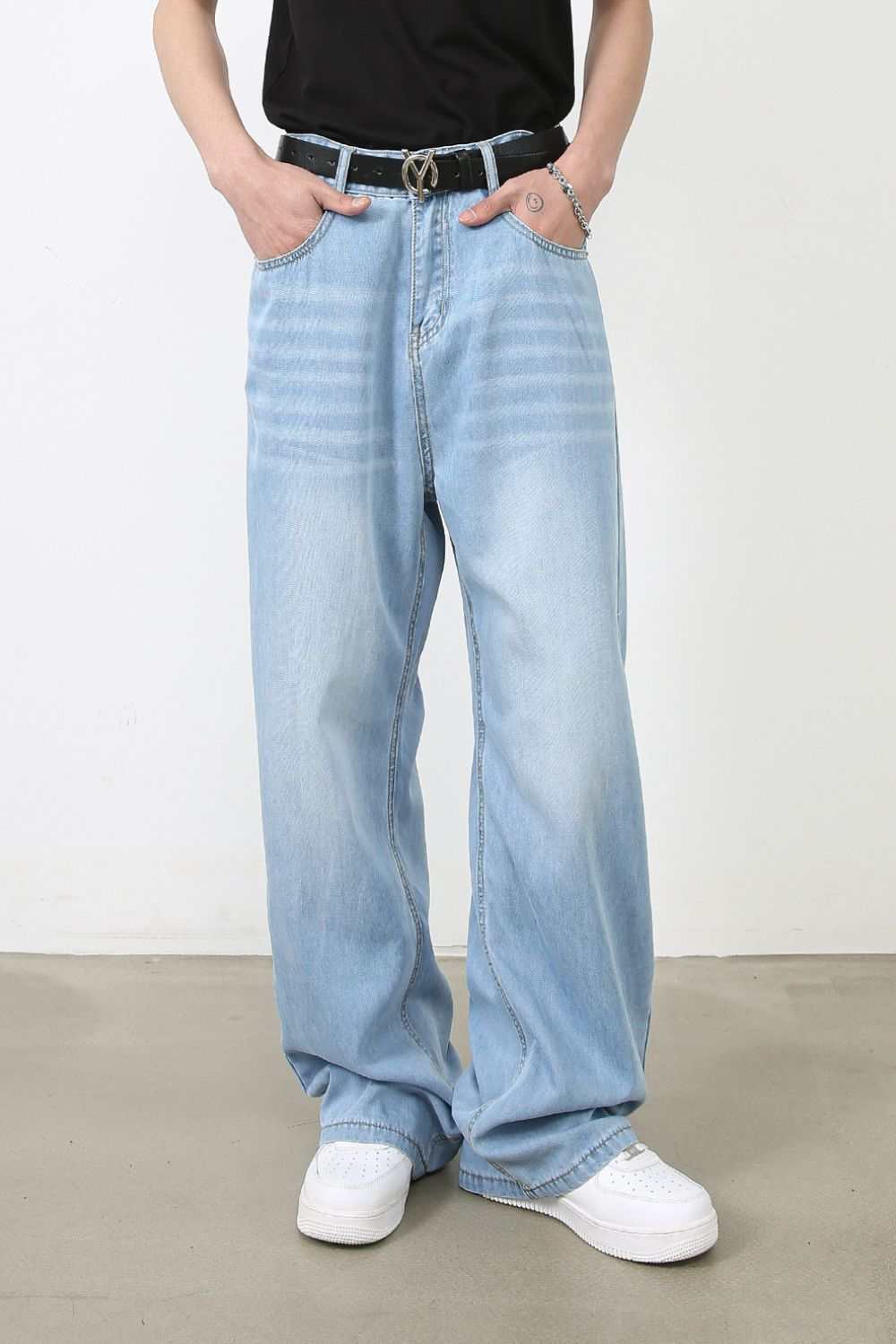 Men's wide leg jeans with pockets, light blue denim, basic style.