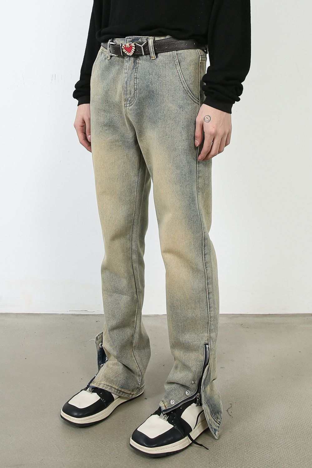 Men's mid-rise jeans, basic style, no stretch, cotton blend, worn by model with black shirt and sneakers.