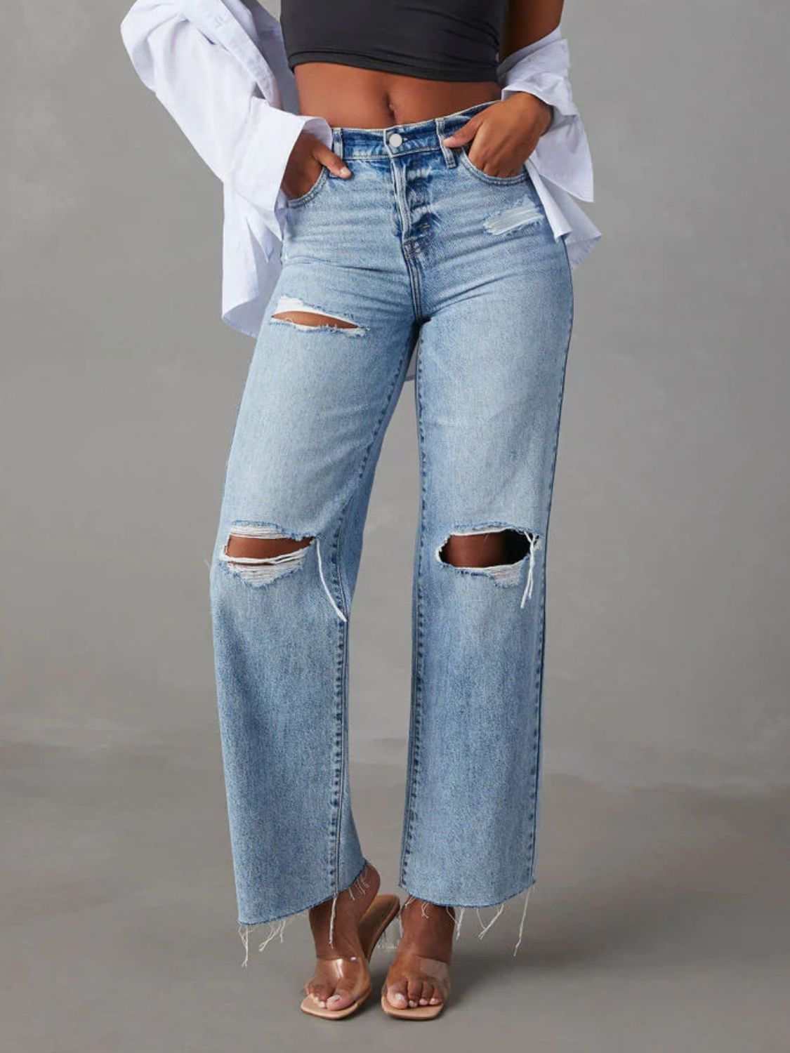 Distressed straight leg jeans with pockets and button details.