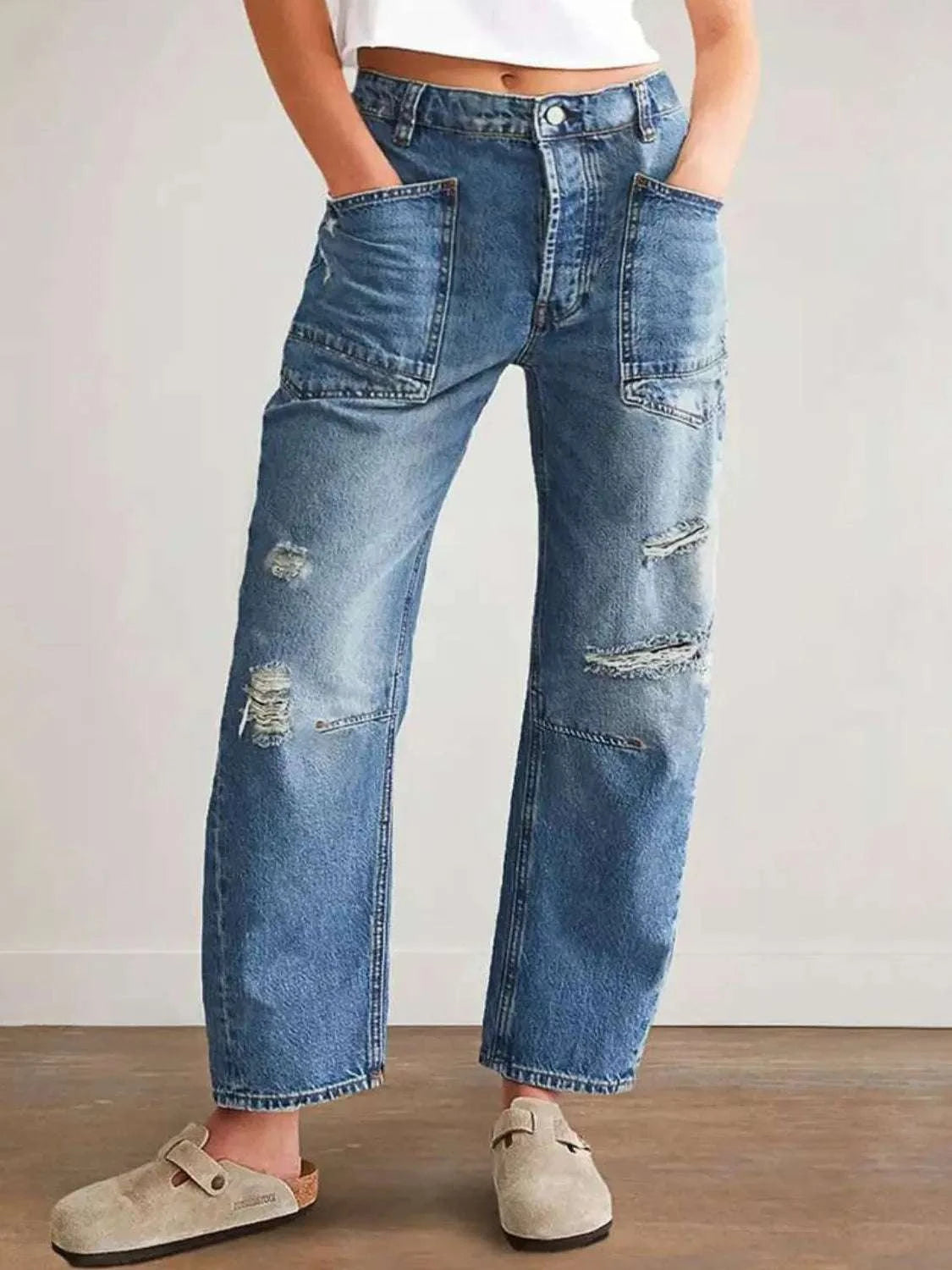Distressed blue jeans with pockets, no stretch, cotton-polyester blend.