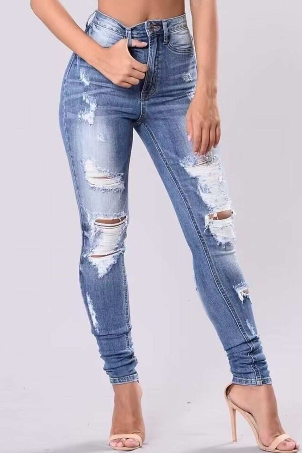Full size distressed skinny jeans in plus size with button and pocket features.