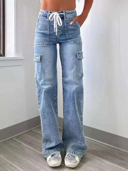 Washed jeans with pockets and tie detail, shown on model.