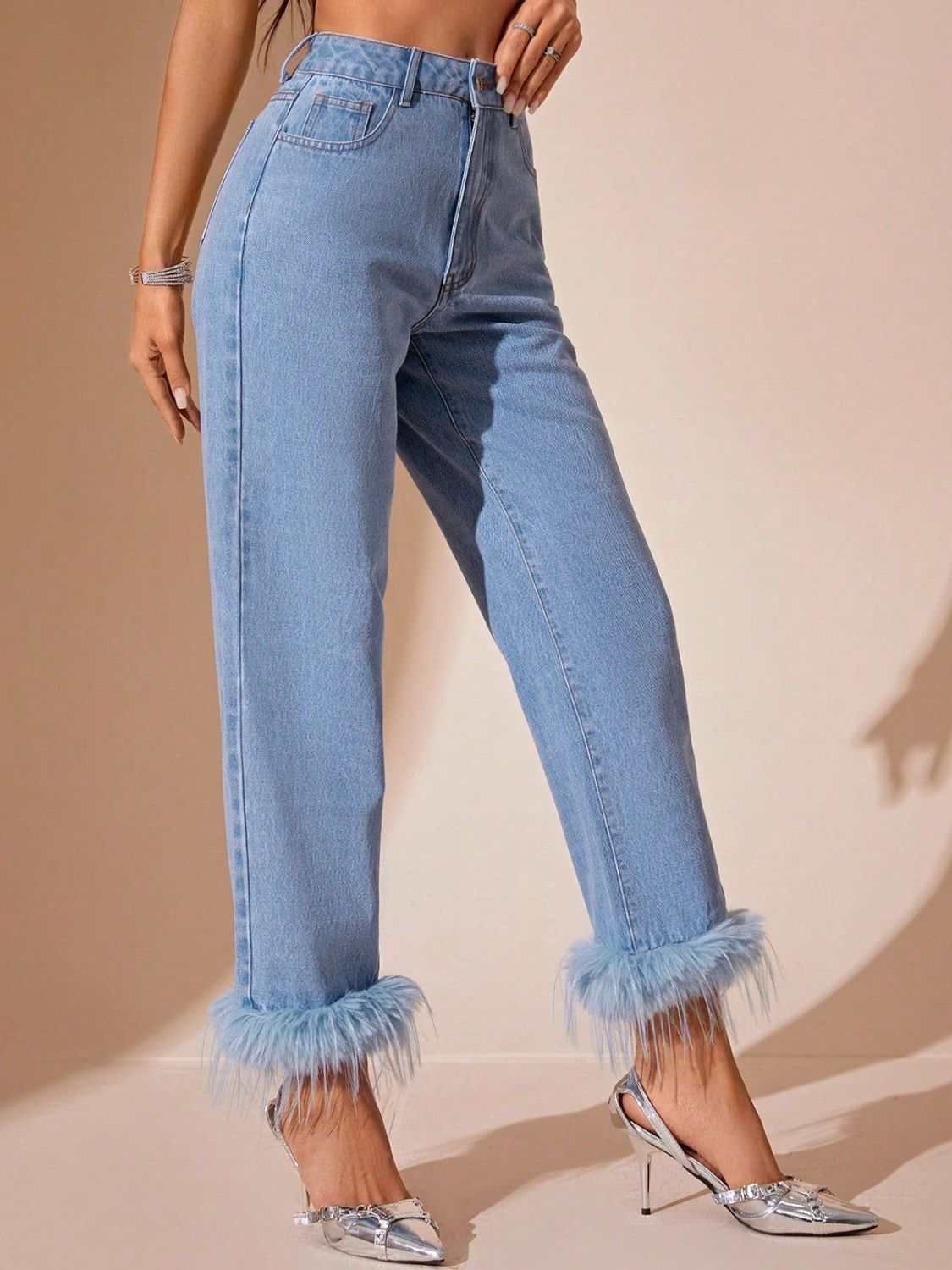 High rise straight jeans with plush hem, button closure, and pocket details.