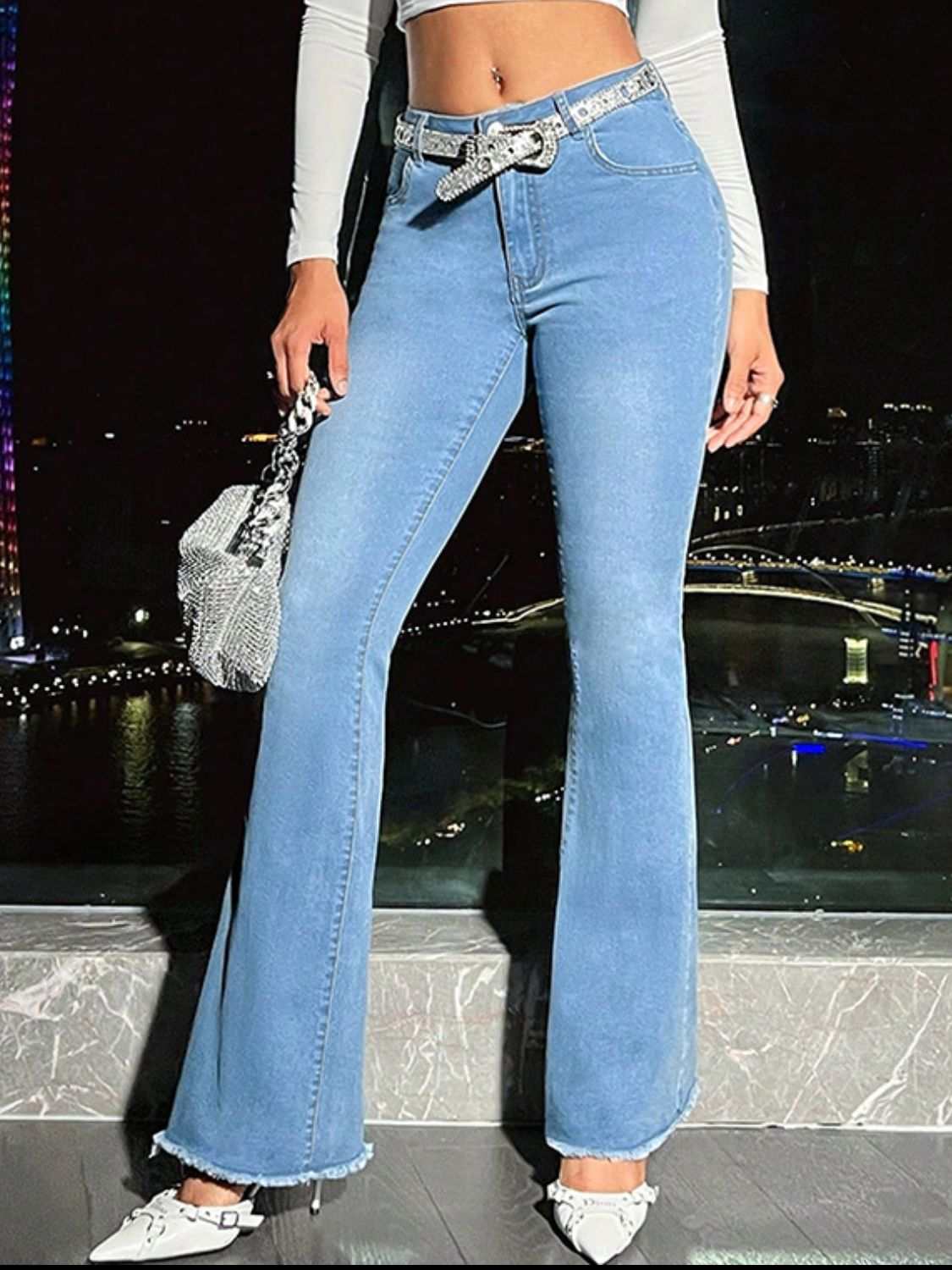 Raw Hem Bootcut Jeans with Pockets, highly stretchy denim, front view, nighttime city background.