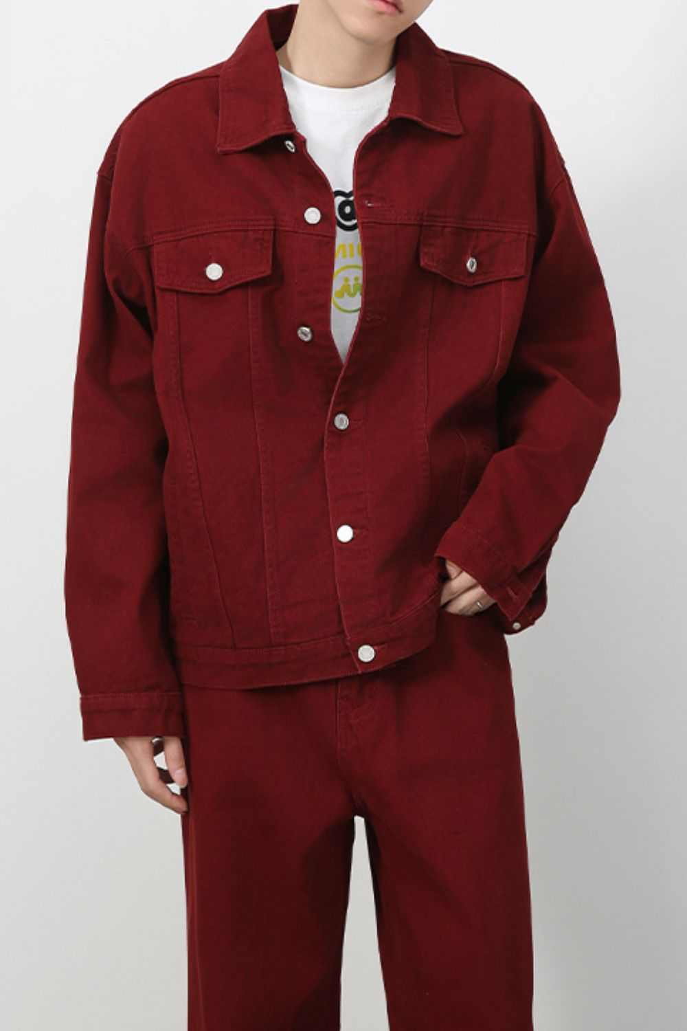 Men's button up red denim jacket with dropped shoulders and front pockets.