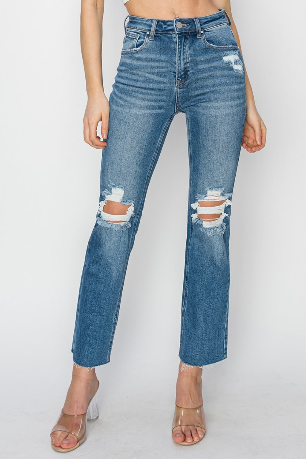 High rise distressed ankle jeans with raw hem and trendy detailing.