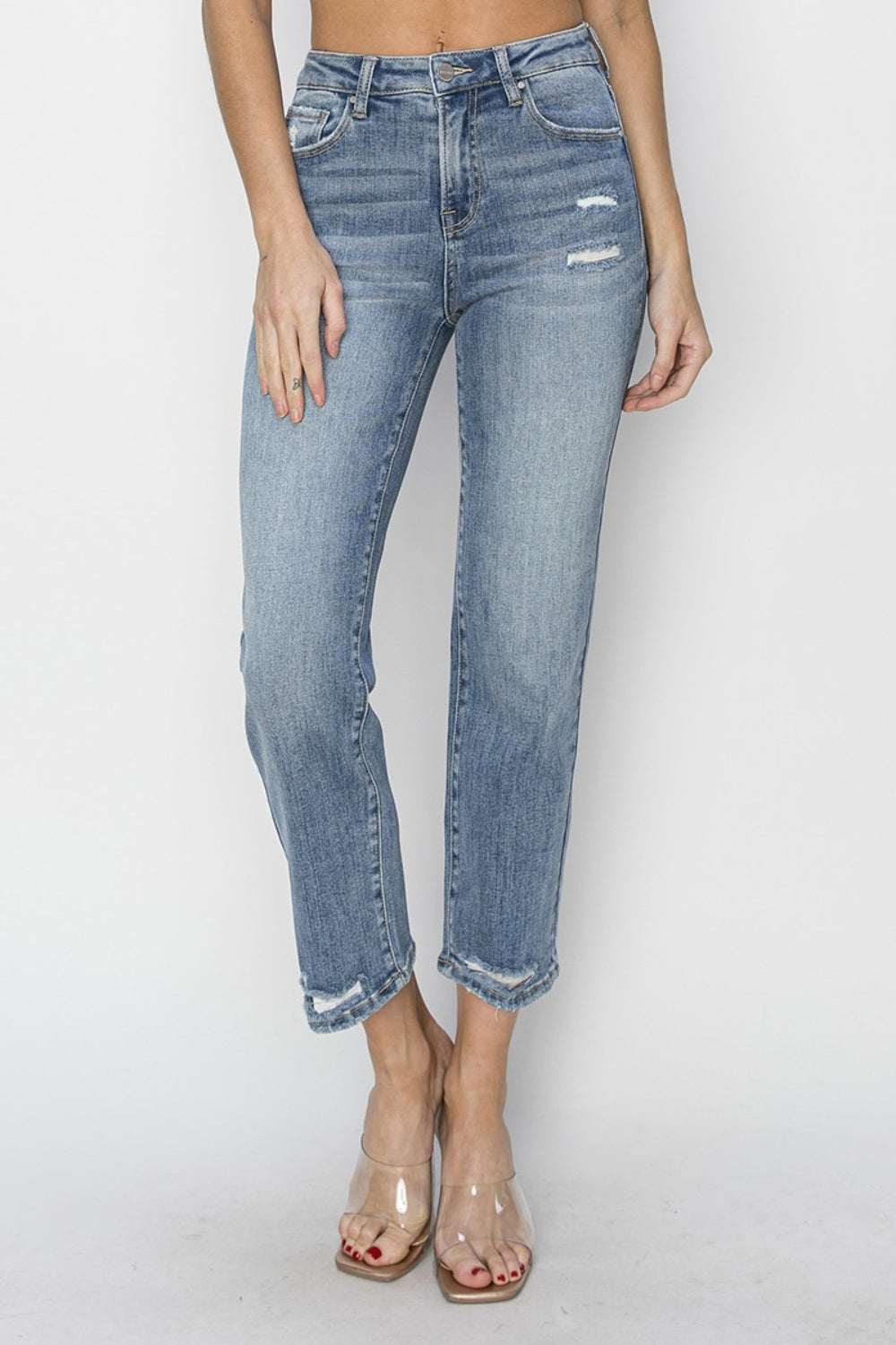 High waist distressed cropped jeans with raw hem and moderate stretch.